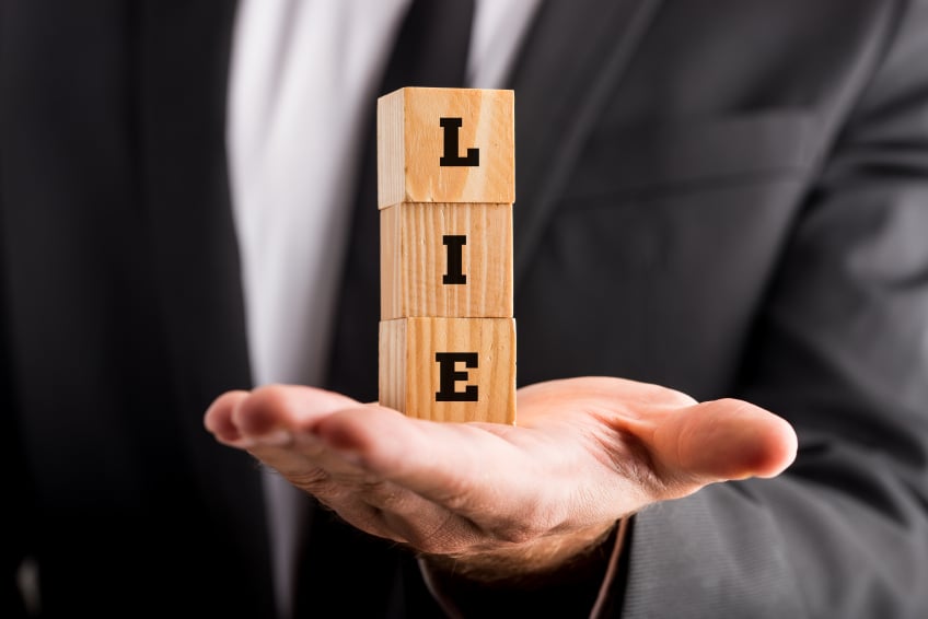 lie spelled out with wooden blocks