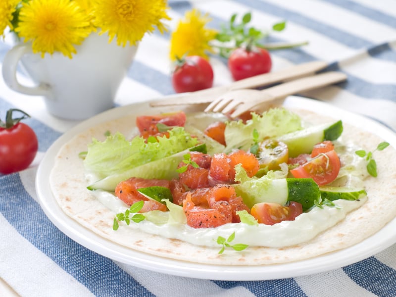 Pita with salmon, tomato and sauce is on of several tasty sandwiches