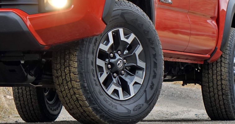 Alloy wheel and Goodyear Wrangler tire on a 2016 Toyota Tacoma TRD Pro.
