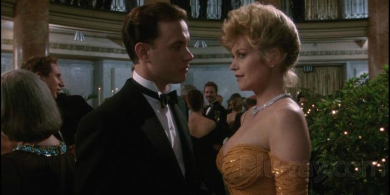 Tom Cruise talks to Melanie Griffith as they are dressed up for a party in The Bonfire of the Vanities.