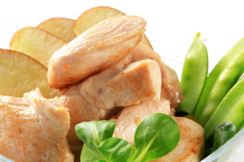 close-up of chicken breast with apples and pea pods