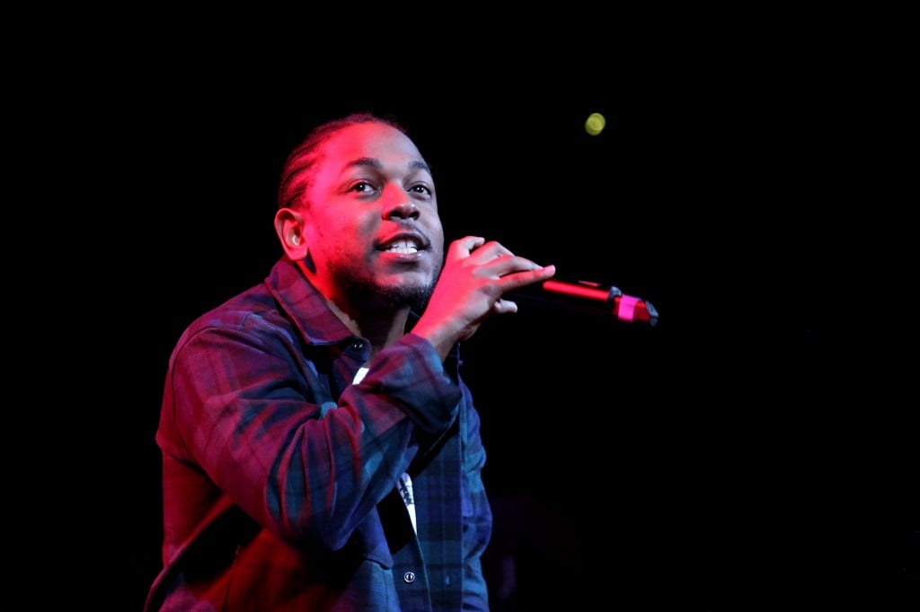 Kendrick Lamar performing on stage. 