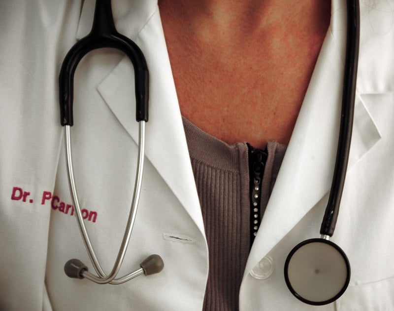 A doctor wearing a medical instrument