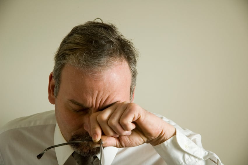 Man rubbing his eyes Man rubbing his eyes