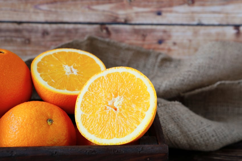 ripe orange in a wooden crate