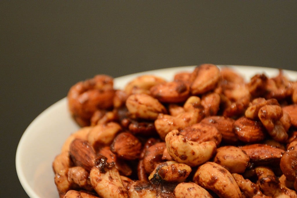 Close up of spicy maple mixed nuts in a white bowl