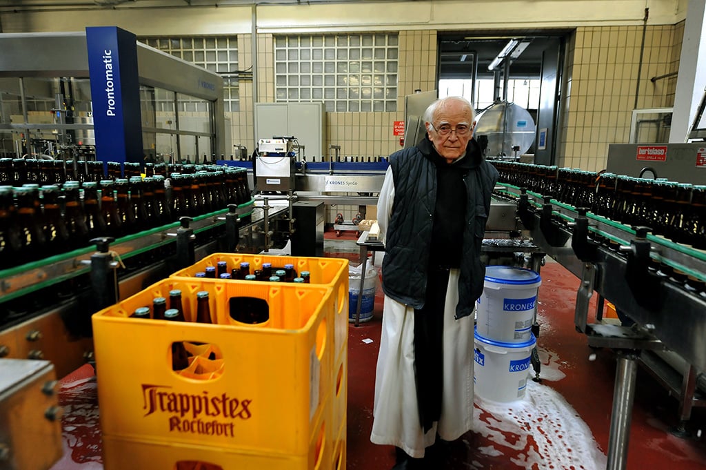 Trappist Monk overseeing beer bottling in Belgium