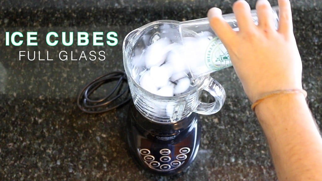 filling a blender with a full cup of ice cubes