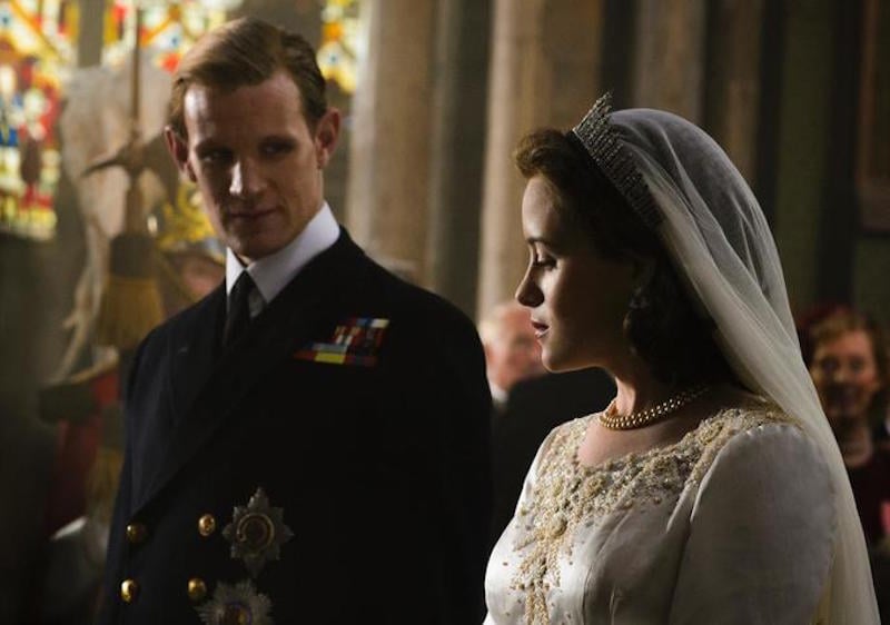 Claire Foy wears a wedding dress and stand next to her husband to be in the Crown