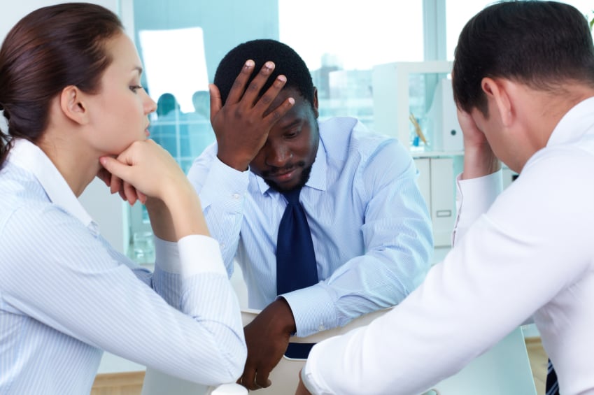 worried members of business team sitting in office