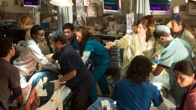 A group of nurses and doctors work on a patient in a scene from Code Black 