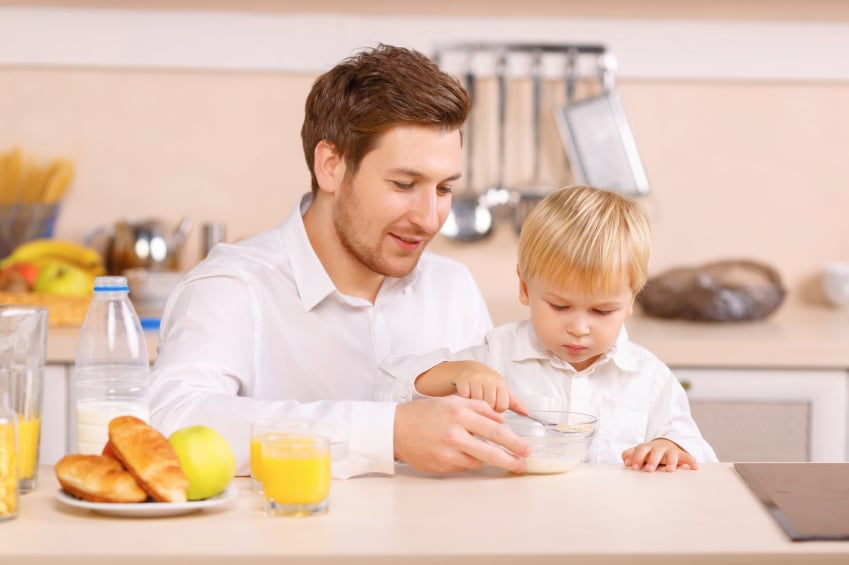 dad eating breakfast with son