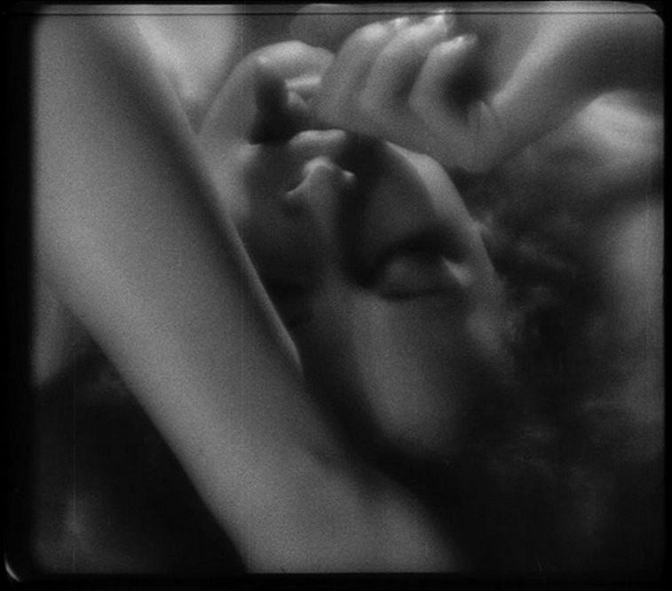 Hedy Lamarr star of Ecstasy (1933) upside down with her eyes closed and her finger in her mouth in black and white