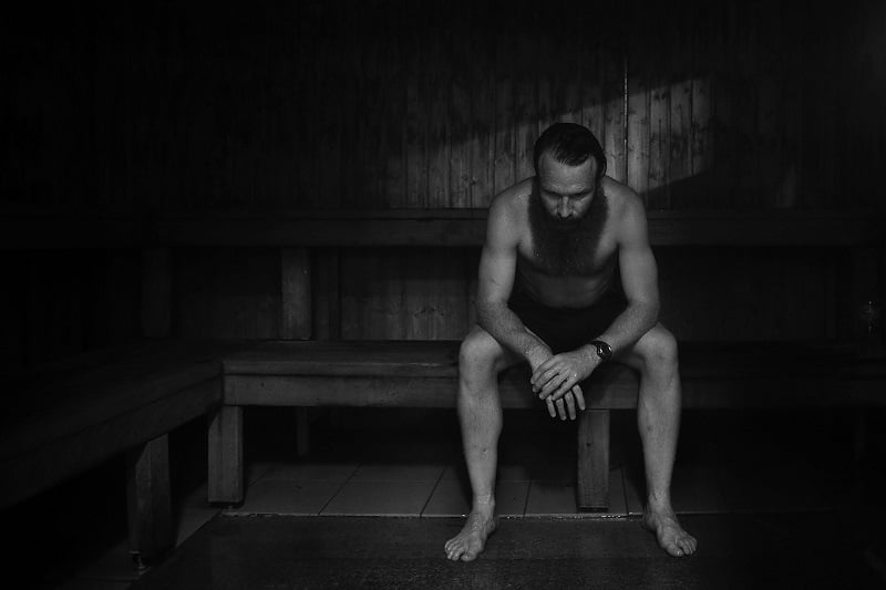 a man sitting in a sauna a man sitting in a sauna