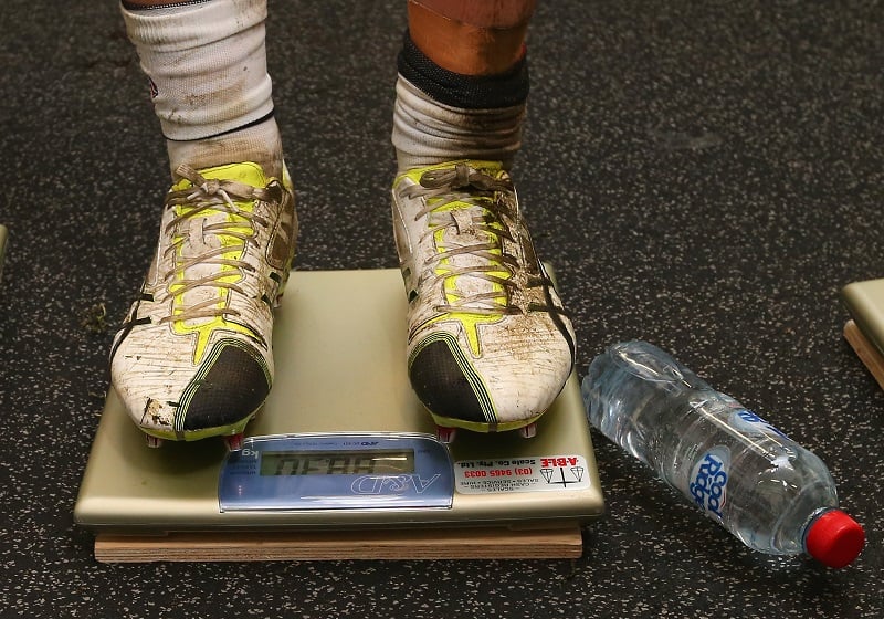 man stepping on a scale man stepping on a scale