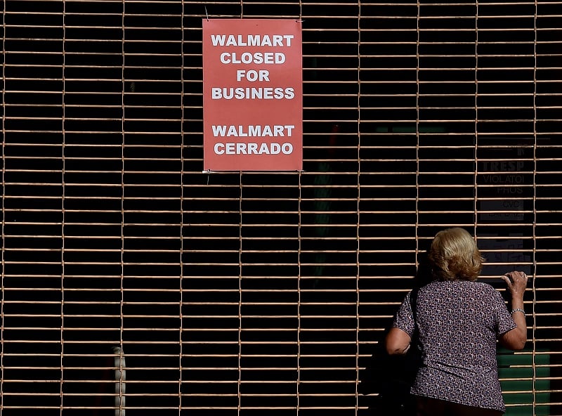 A woman at a closed Walmart trying to make sense of it all