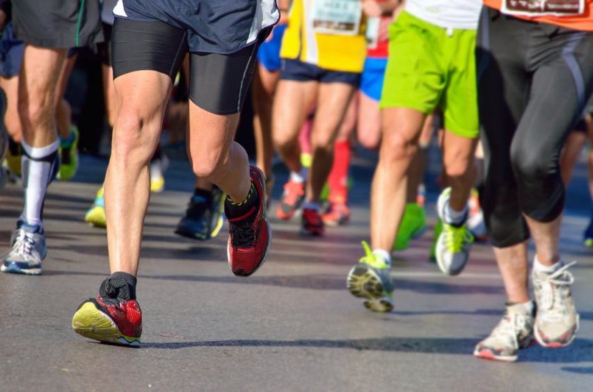 shot of runners legs during a road race