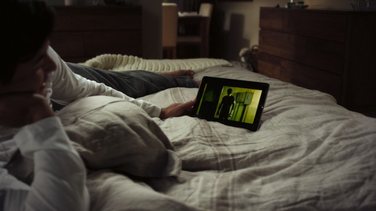 Netflix user watching a movie on a tablet