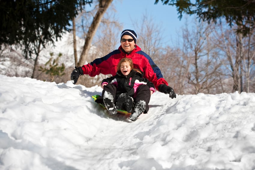 man and child sledding