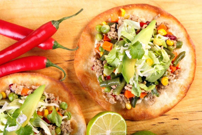 crispy tostadas or tacos with ground meat, veggies, and avocado