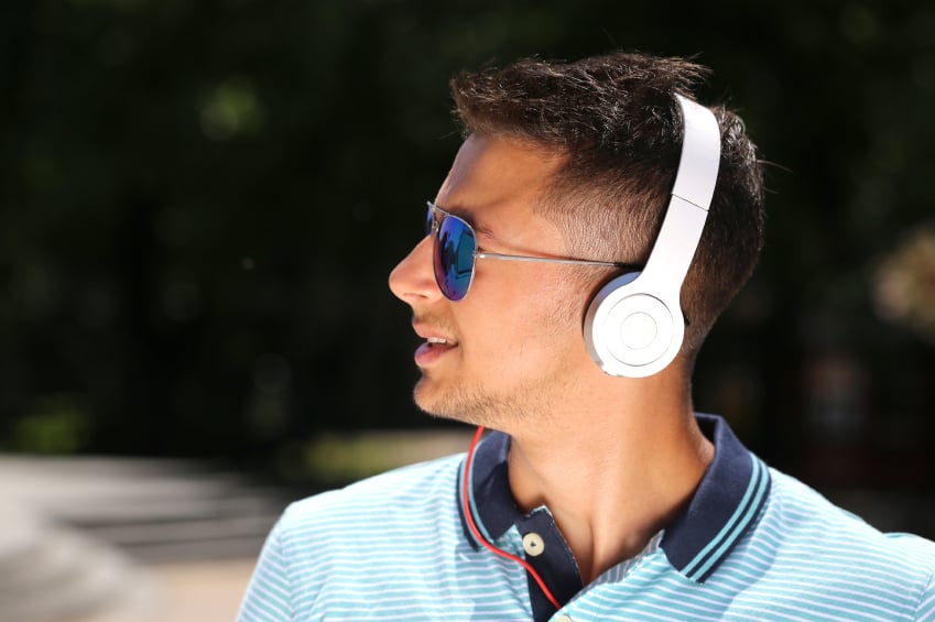 young man listening to music with headphones