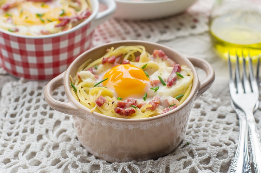 ramekin of baked pasta carbonara with an egg and pancetta