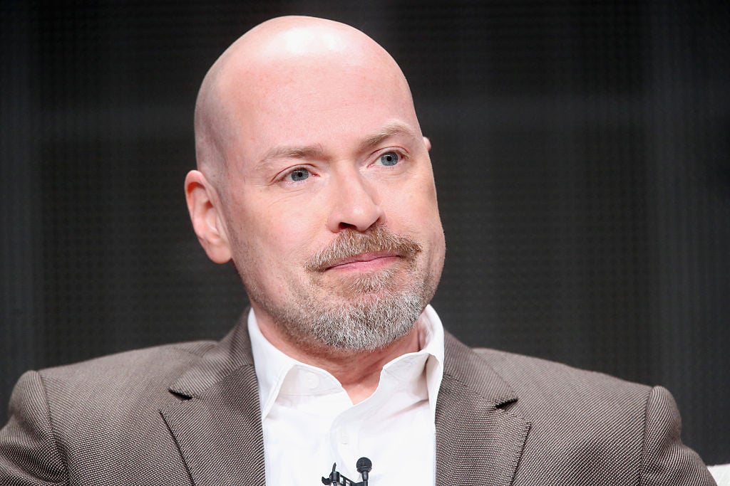 Steven DeKnight in a suit answering questions