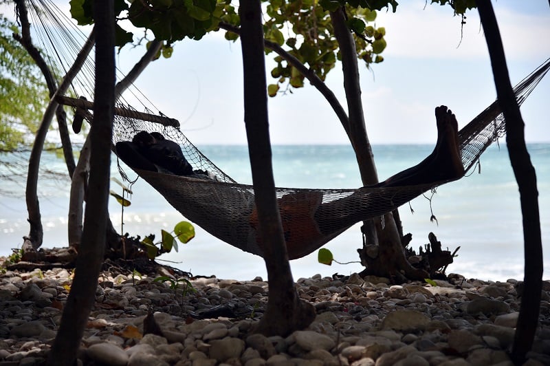 A man sleeps in a hammock close to the beach in the commune of is Anse-a-Pitres, in the South East Department of Haiti, on October 14, 2015