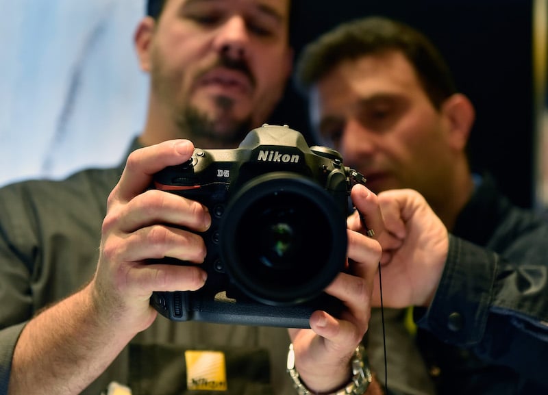 Two men look into a camera's display