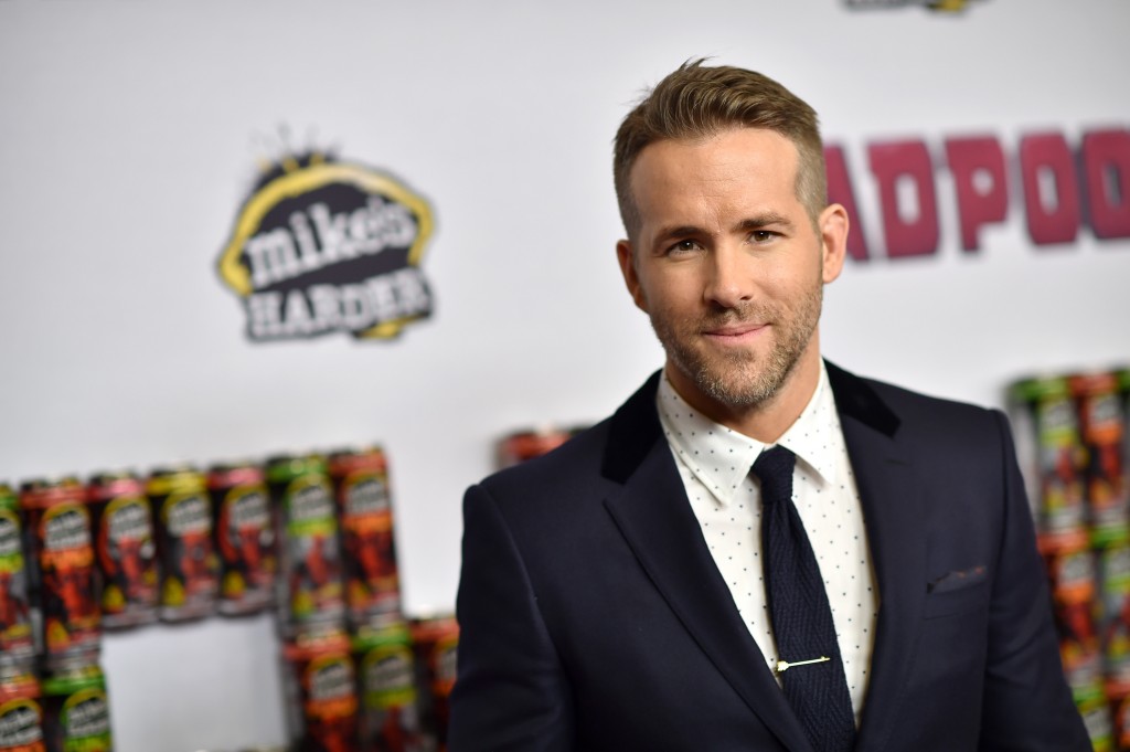 Ryan Reynolds is in a black suit while on the red carpet.