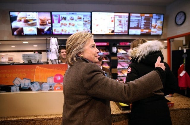 Democratic presidential candidate Hillary Clinton orders food at a Dunkin' Donuts on February 9, 2016 in Nashua, New Hampshire