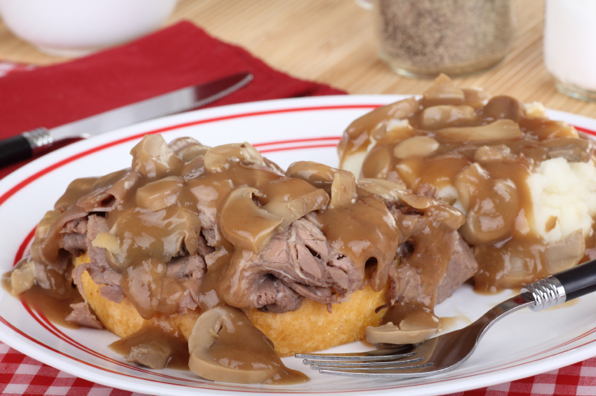 hote roast beef and gravy sandwich with a side of mashed potatoes