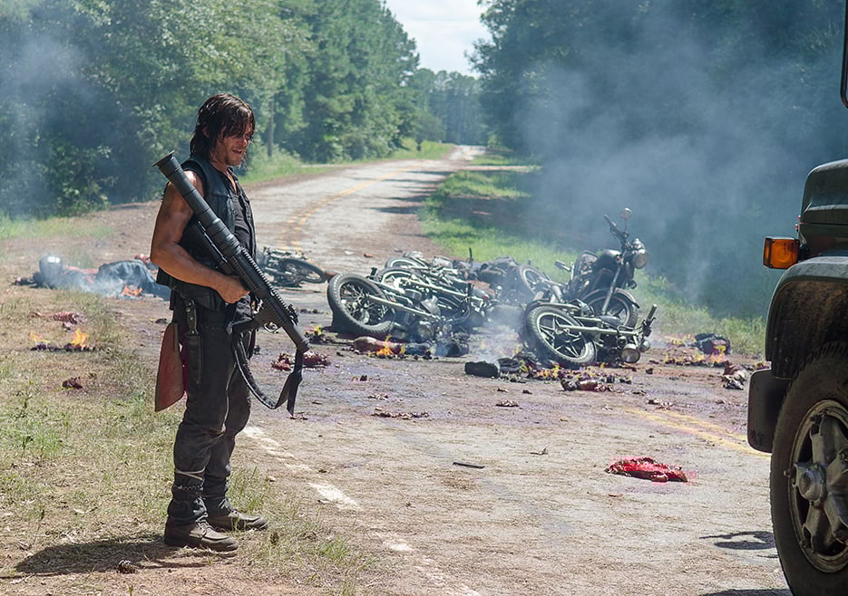 Daryl stands in a street in front of crashed motorcycles Daryl stands in a street in front of crashed motorcycles