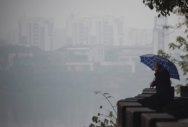 a man holds an umbrella in China
