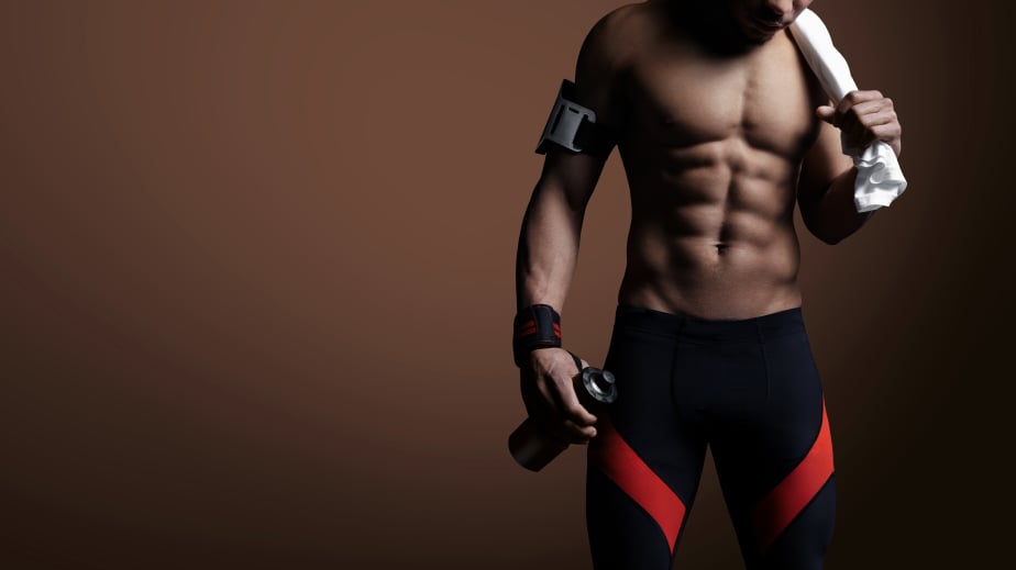 Young athlete with towel and bottle of water