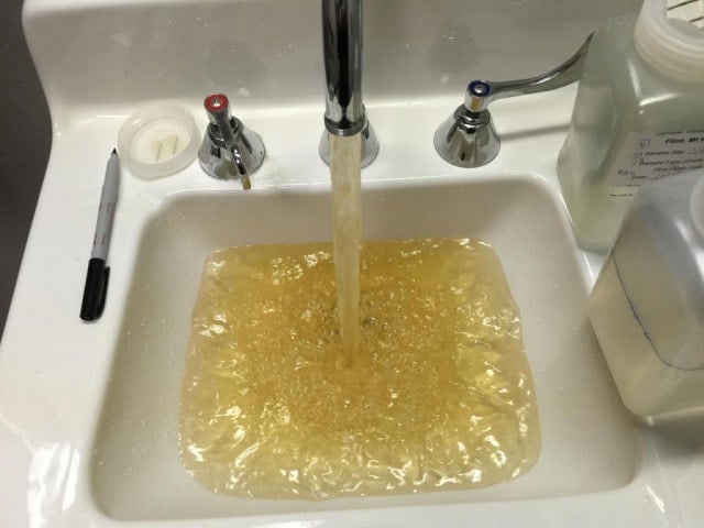 A running faucet releases lead-tainted water into a bathroom sink in Flint, Michigan.