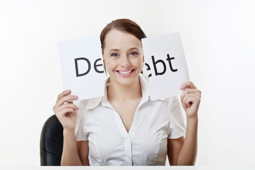 woman holding teared debt sign