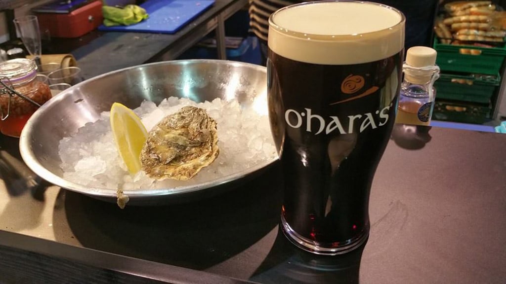 a raw oyster paired with O'Hara's Irish Stout