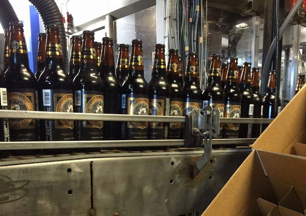 bottles of North Coast Brewing's Old Rasputin stout being produced