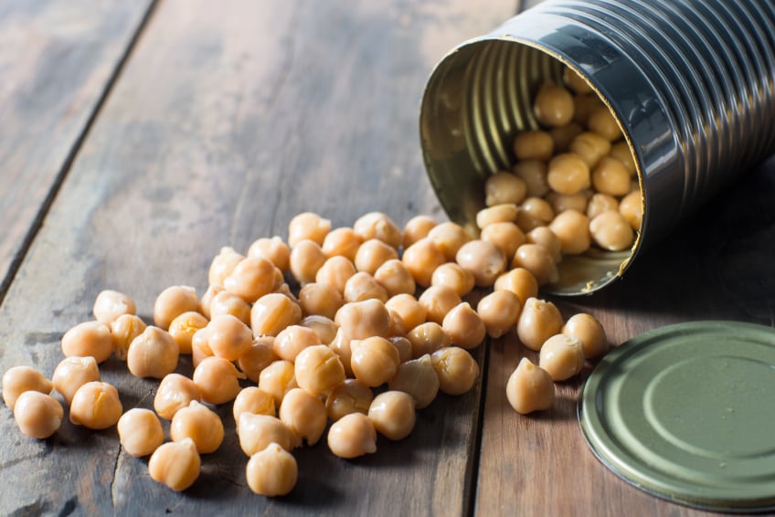 opened can of garbanzo chick peas on a wooden table