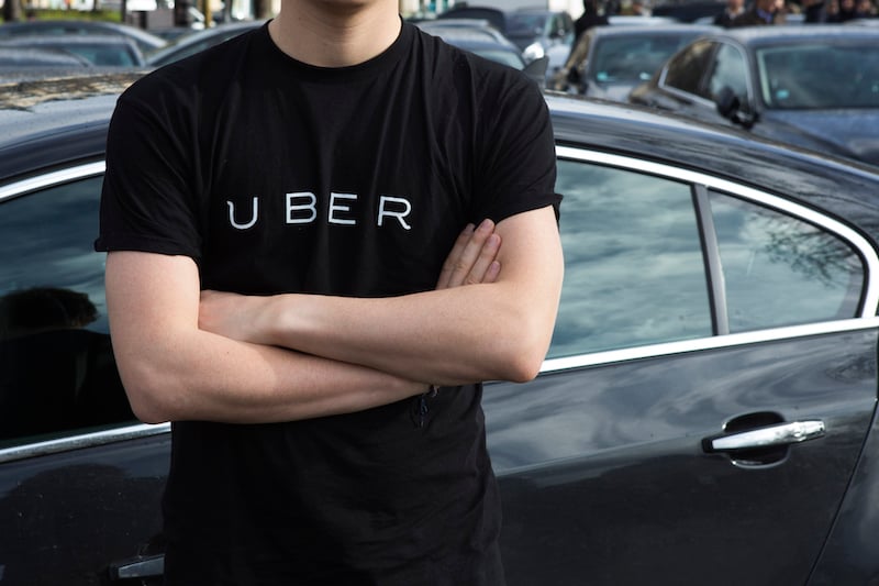 A-protester-wears-a-shirt-displaying-the-logo-of-smartphone-ride-service-Uber-.jpg