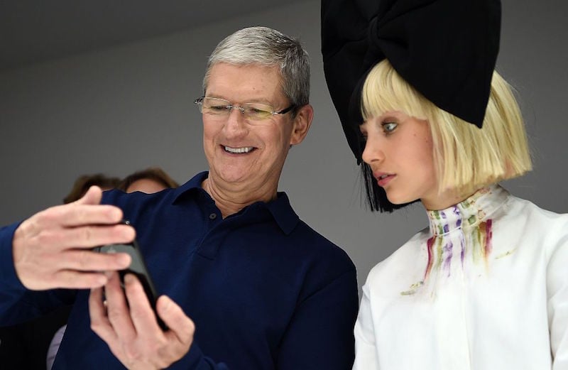 Apple CEO Tim Cook (L) shows dancer Maddie Ziegler (R) a new iPhone during a product demonstration at Bill Graham Civic Auditorium in San Francisco, California on September 07, 2016. 