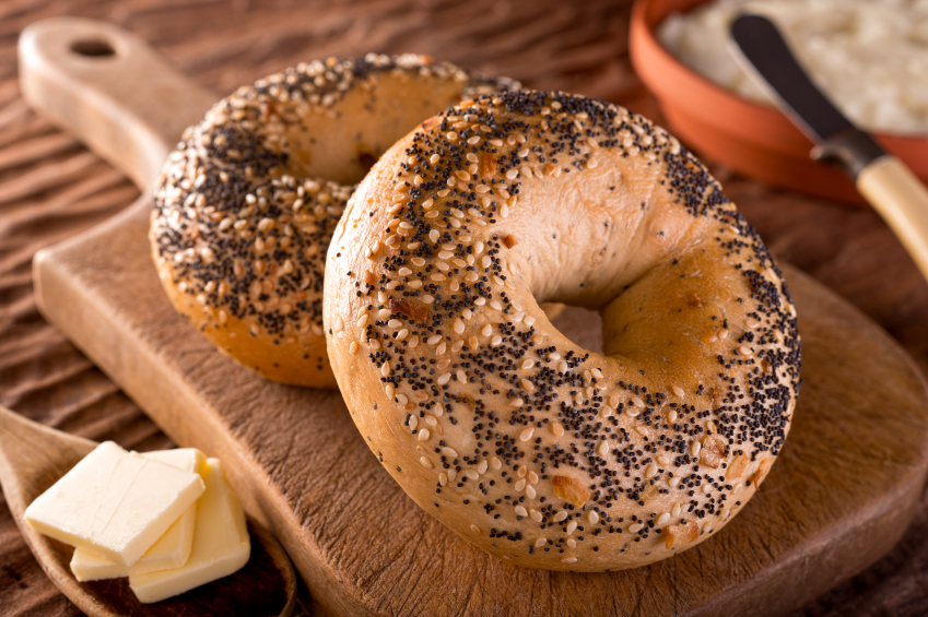 two everything bagels on a wooden background two everything bagels on a wooden background