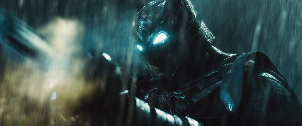 Ben Affleck's Batman with his eyes lit up in the rain as he prepares for battle in Batman v Superman: Dawn of Justice