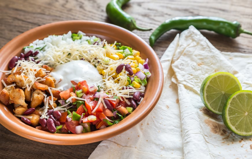 Chicken burrito bowl with rice, salsa, corn, and beans