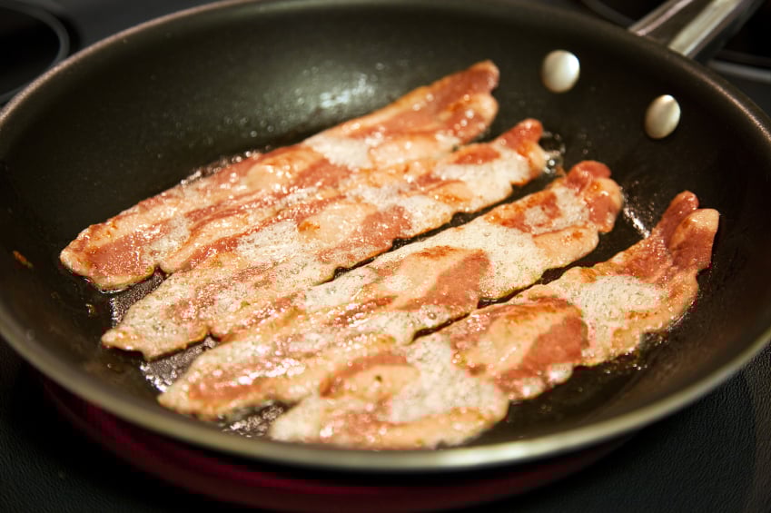 turkey bacon cooking in a skillet