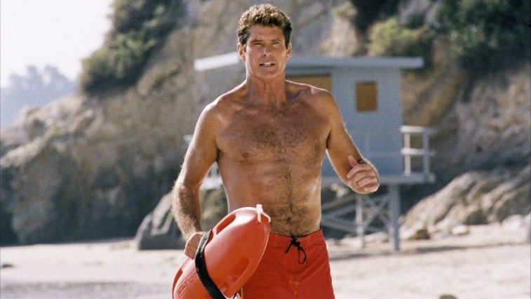 David Hasselhoff is running on the beach as a lifeguard.