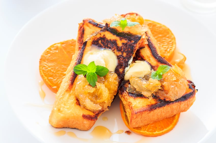 Grench toast with sliced oranges and butter