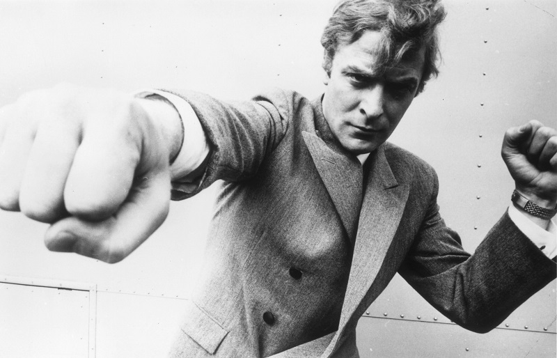 A man in a suit throwing a punch