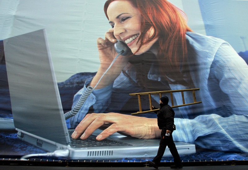 Worker strolls past work from home billboard